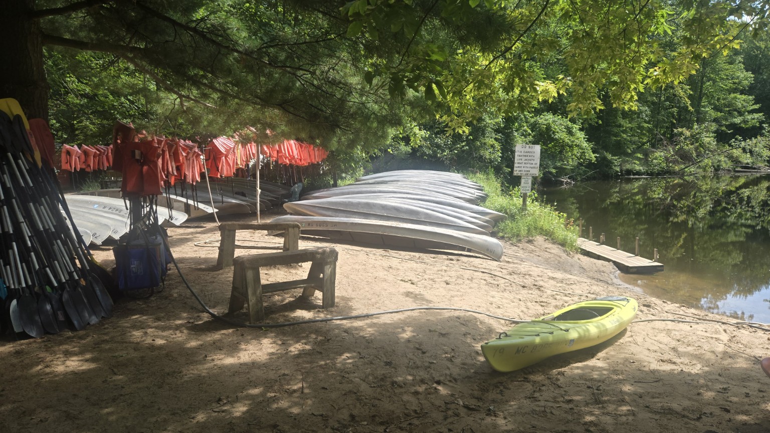 Single kayak beside the Tip-A-Thumb canoe fleet and Pinnebog River