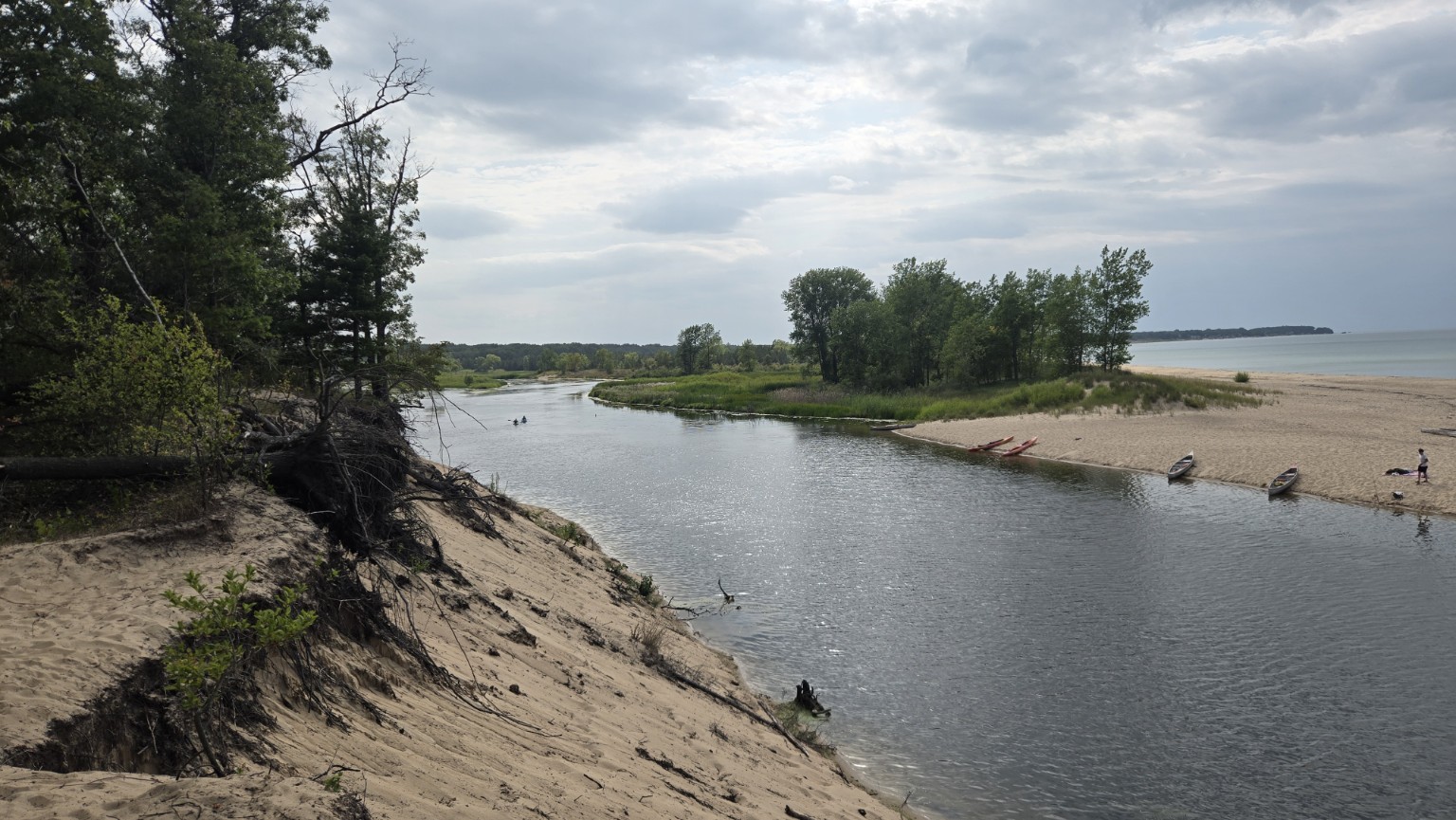Scenic view of the river flowing toward the sandy Lake Huron beach near Port Austin